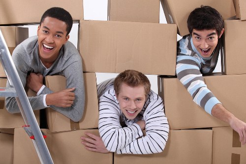 Local movers carrying furniture on a residential street in Crystal Palace